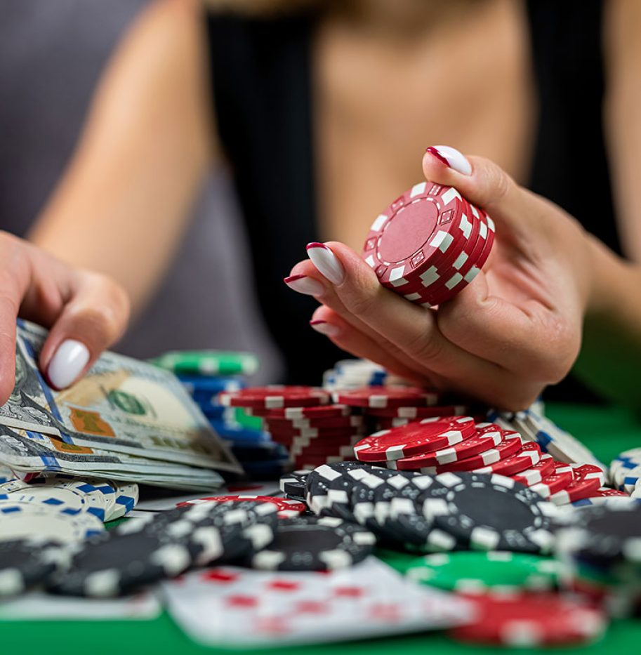 female-player-counts-chips-money-raises-bet-while-playing-poker-casino female-player-counts-chips-money-raises-bet-while-playing-poker-casino